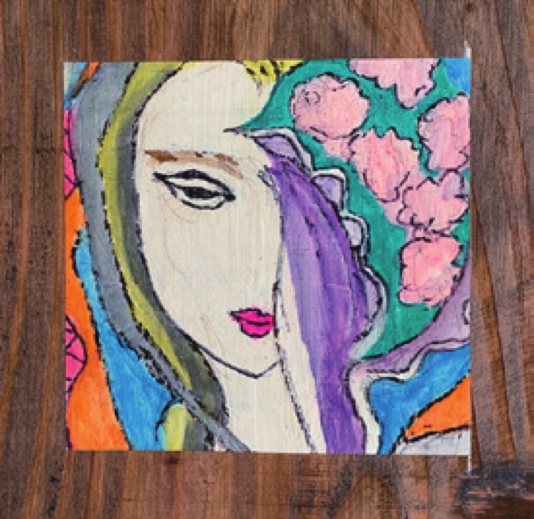 利用者が描いた女性の顔のアート作品